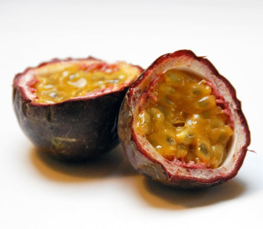 Passiflora edulis ripe fruit with dark purple skin and juicy yellow pulp seeds